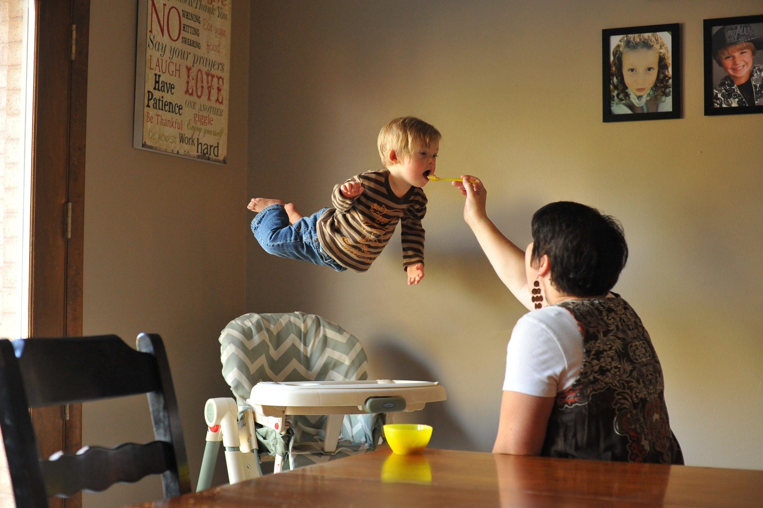 PHOTO: Wil takes flight while his mom feeds him.