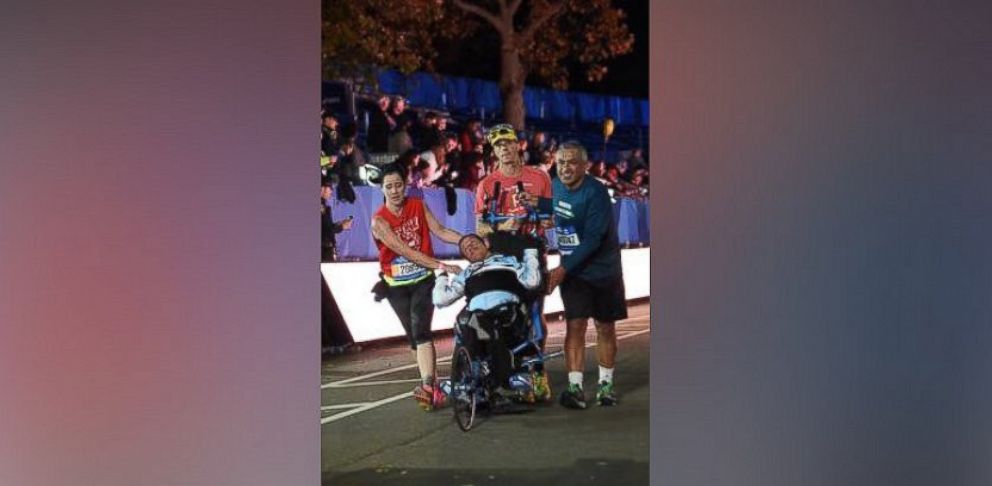 PHOTO: Kyle and Brent Pease completed the 2015 New York City marathon thanks to the assistance of two runners who helped carry Kyle to the finish line.