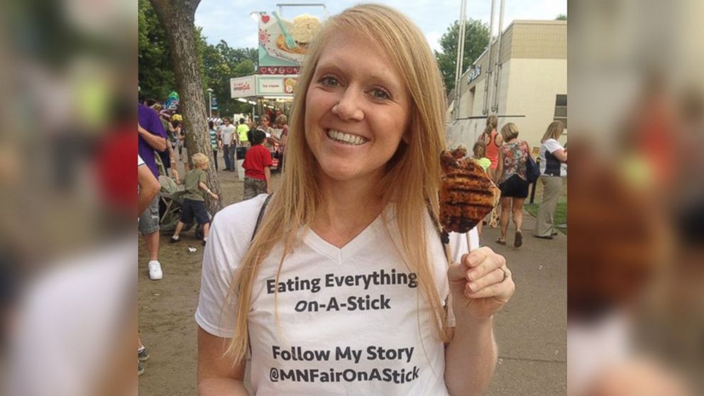 Mandy Colten eating chicken on a stick for charity.