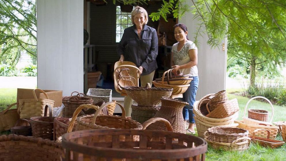 Martha Stewart and housekeeper Sanu Sherpa carry out baskets from Stewart's "basket house" on her farm in Bedford, N.Y.