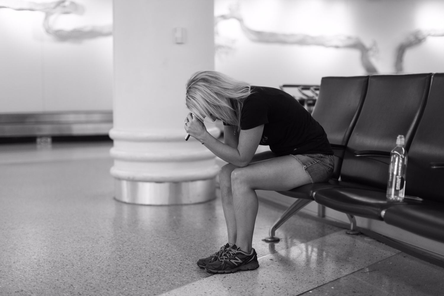 PHOTO: Sarah Lynn Olson anxiously waits out a flight delay as she and her husband David wait to board a flight to meet their daughter. 