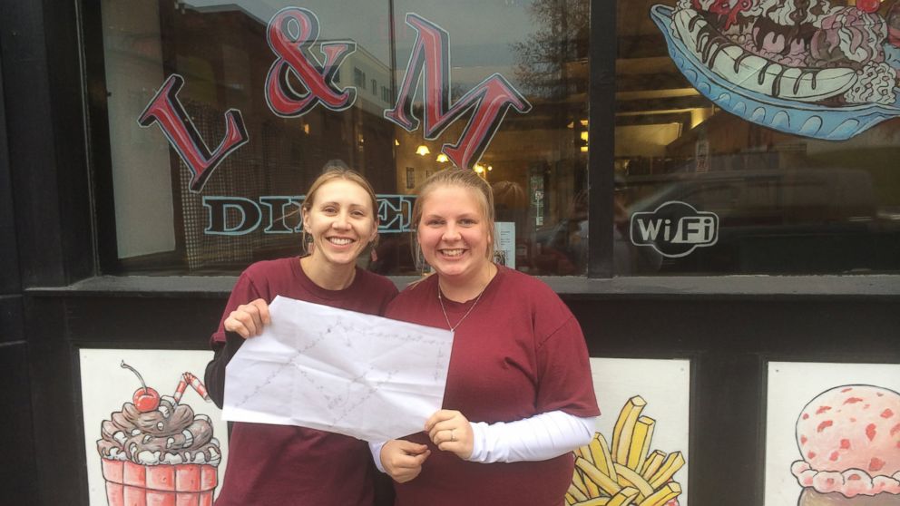 Tayler Merriam and another server outside L&M Diner, where 46 tables participated in a pay-it-forward chain.