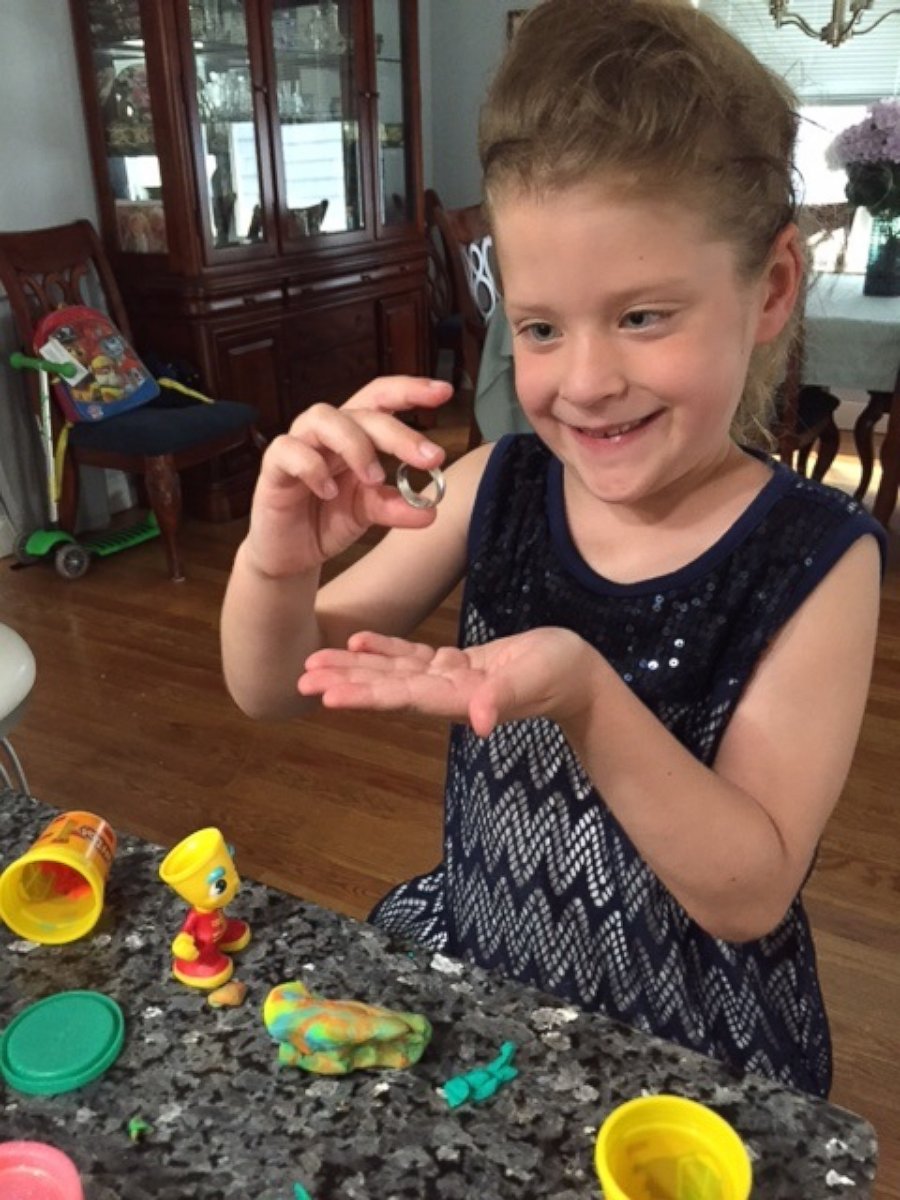 PHOTO: Little girl finds a wedding band in her box of Play-Doh. 
