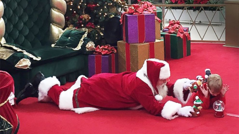 PHOTO: A little boy who didn't want to sit in Santa's lap got to bond with him on the floor instead. 