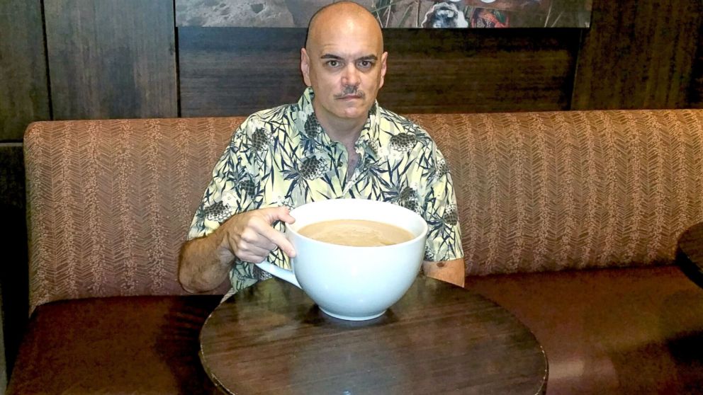 Bill Lewis with his record-breaking 160-ounce Starbucks latte.