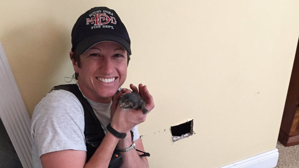 Mount Dora, Florida, firefighter Tara Holcomb adopted the kitten she rescued from inside a home's walls.