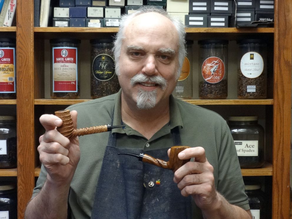 PHOTO: Minneapolis pipe maker Richard Lewis shows off two of the pipes he makes and sells at Lewis Pipe and Tobacco.