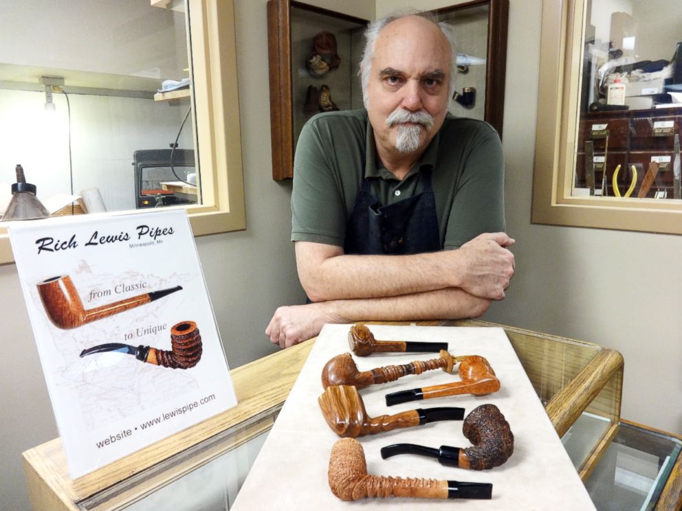 PHOTO: Richard Lewis with a display of hand crafted pipes at his Minneapolis tobacco shop.