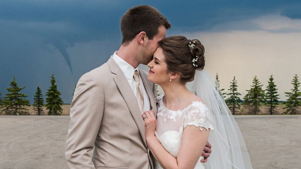 Kipp and Kelsey Loeslie's wedding photo includes a funnel cloud in the distance.