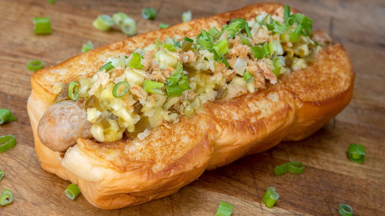 PHOTO: A Huli-Huli chicken and pork sausage topped with King's Hawaiian Sweet Island Ginger Sauce, bouillonnaise, pineapple and jalapeno relish, crispy fried onions and scallions.