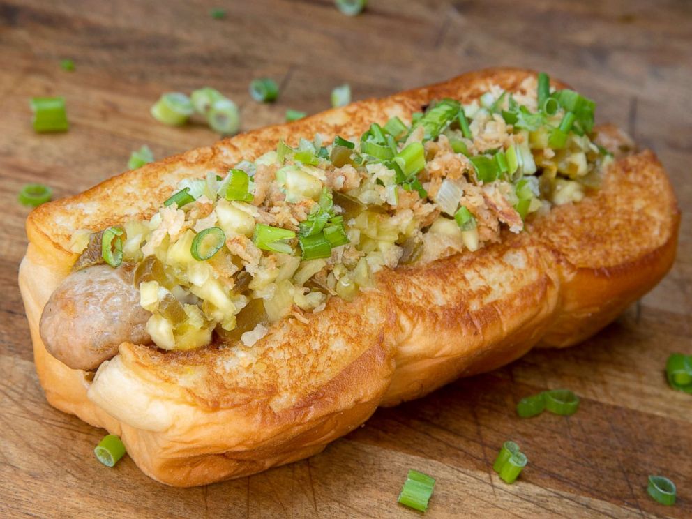 PHOTO: A Huli-Huli chicken and pork sausage topped with Kings Hawaiian Sweet Island Ginger Sauce, bouillonnaise, pineapple and jalapeno relish, crispy fried onions and scallions.