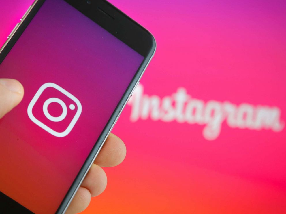 PHOTO: The logo of Instagram is displayed on a smartphone on September 27, 2016. Instagram has announced that they have unveiled new settings to help fight cyberbullying.