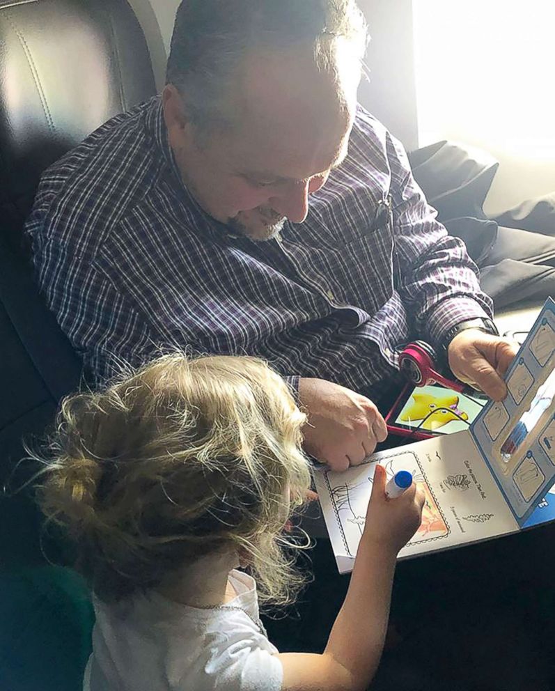 PHOTO: Todd Walker, 52, of Lenexa, Kansas, seen on April 10 coloring with Caroline Rudeen, 3, on a flight from Kansas City, Missouri, to North Carolina.