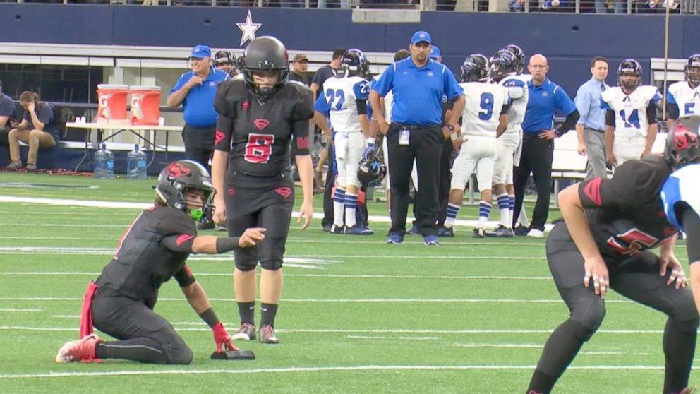 PHOTO: K-Lani Nava became the first female to play in a Texas state championship football game and holds the UIL Class 1A Division II six-man championship football game trophy in Arlington, Texas.