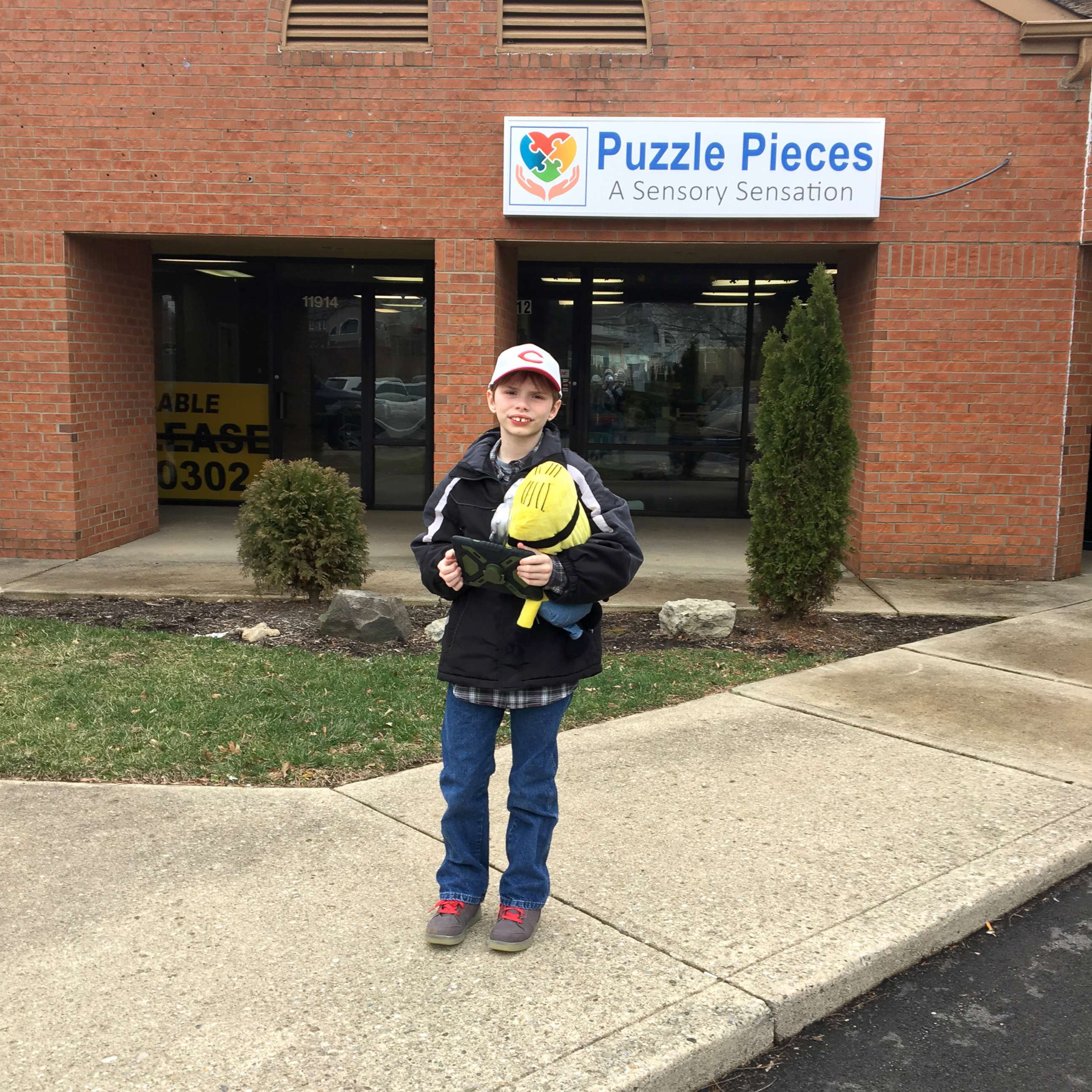 PHOTO: Parker Kahle, 13, stands near the storefront of Puzzle Pieces - A Sensory Sensation, in an undated photo.