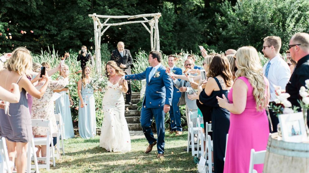 Guests at Kait Olidis and Benett Hallas' wedding on Aug. 26, 2017 threw dried rose petals from Olidis' father's funeral held two years earlier.