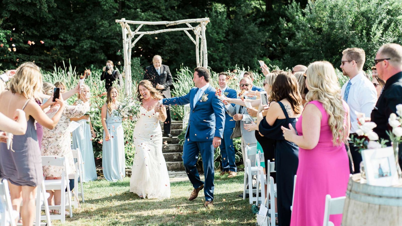 PHOTO: Guests at Kait Olidis and Benett Hallas' wedding on Aug. 26, 2017 threw dried rose petals from Olidis' father's funeral held two years earlier.