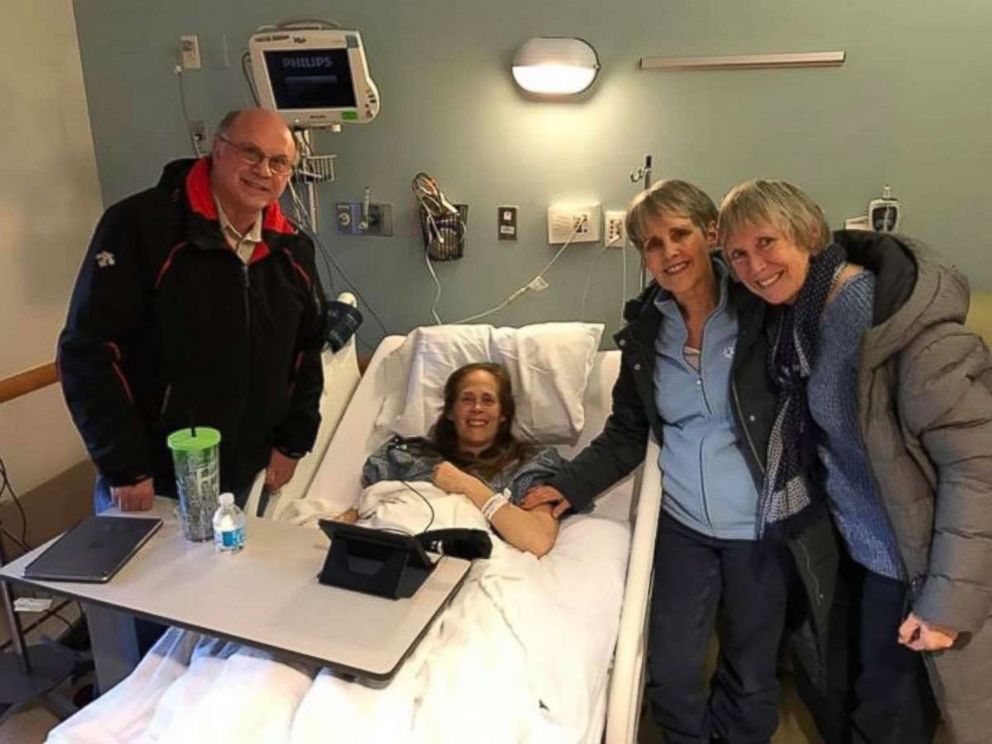PHOTO: Kara Yimoyines seen as a patient at Tufts Medical Center in Boston, Massachusetts, with her father F. Barry Knotts (left), mom Wendy Horton and step mother, Denise Knotts. 