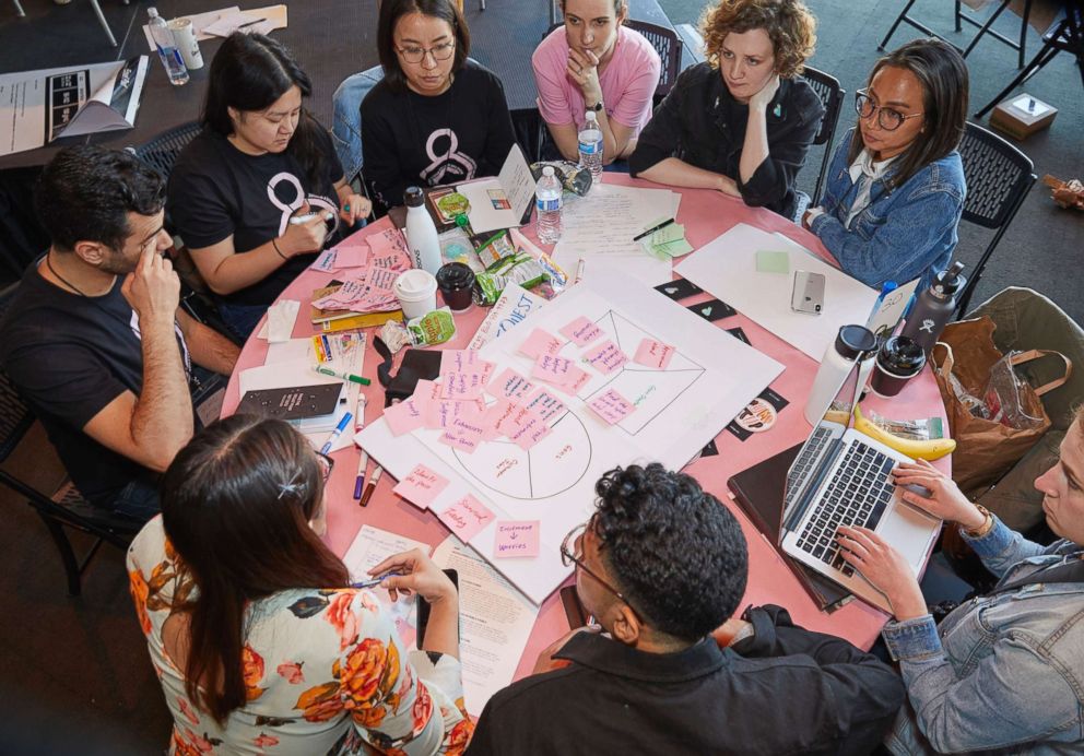PHOTO: Participants discuss ideas at the 2018 Make the Breast Pump Not Suck Hackathon at MIT.