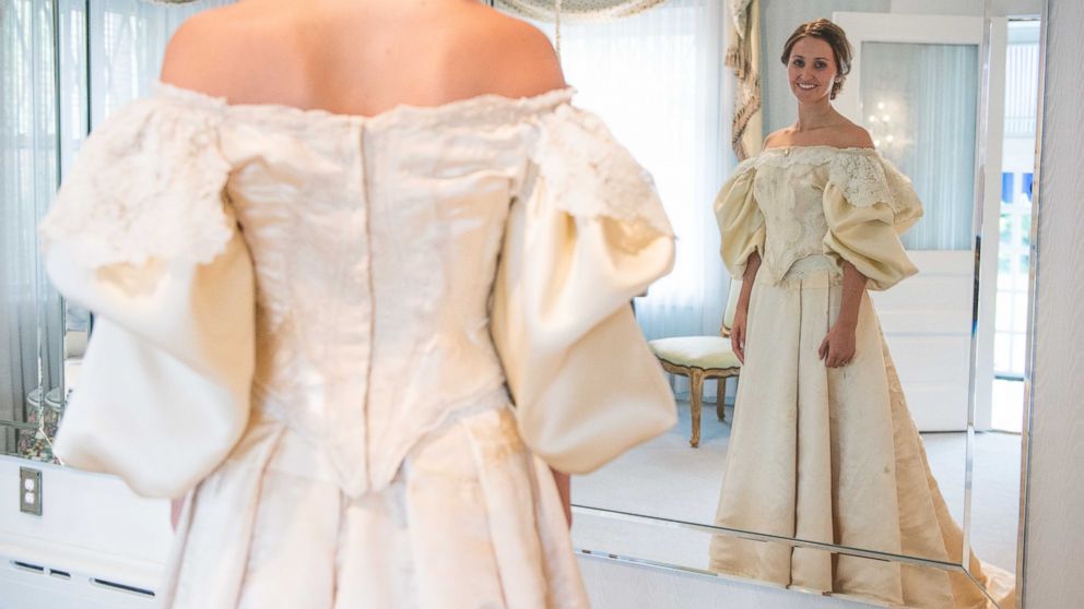 Abigail Kingston tries on a wedding dress, Sept. 22, 2015 that has been passed down in her family for over 100 years and will be the 11th bride to wear it.  