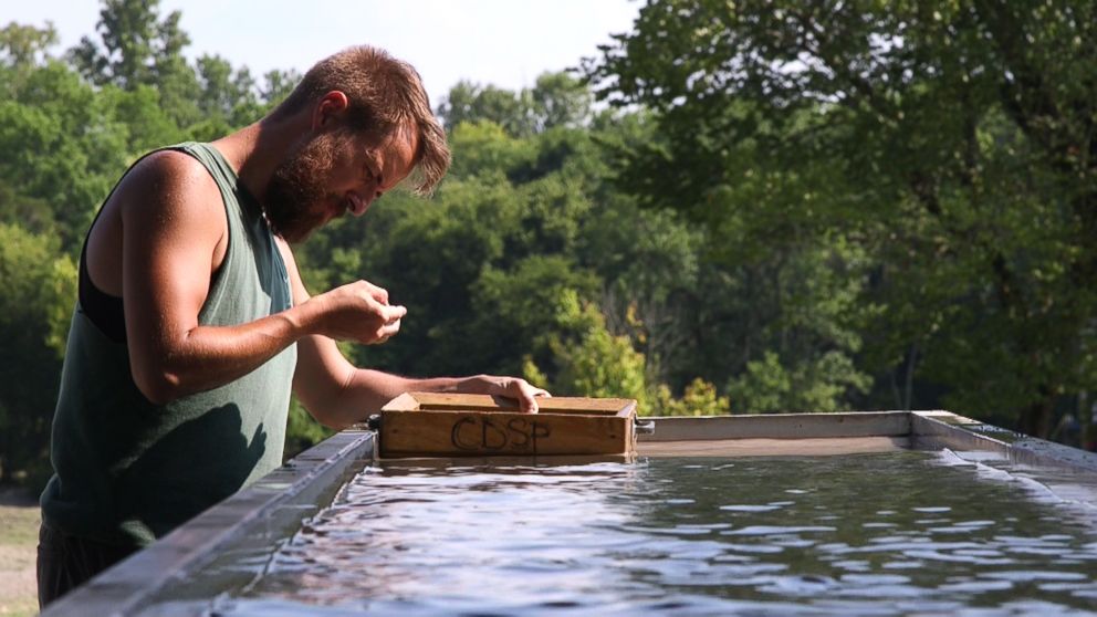 PHOTO: A man uses water to help sift through dirt at Crater of Diamonds State Park in Murfreesboro, Ark.