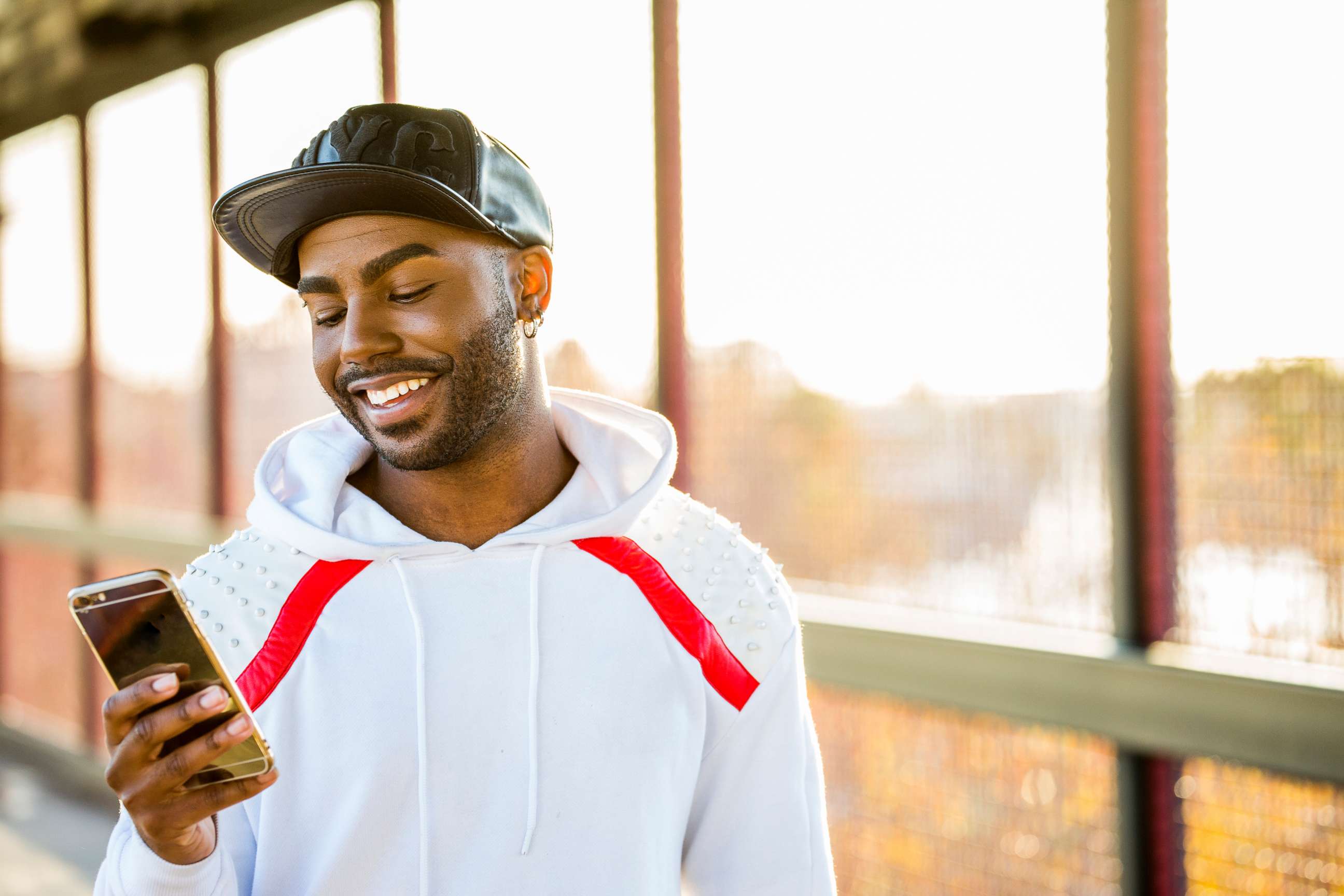 PHOTO: A man smiles as he uses his cell phone in this undated stock photo.