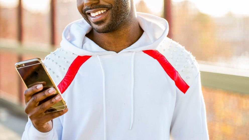 PHOTO: A man smiles as he uses his cell phone in this undated stock photo.