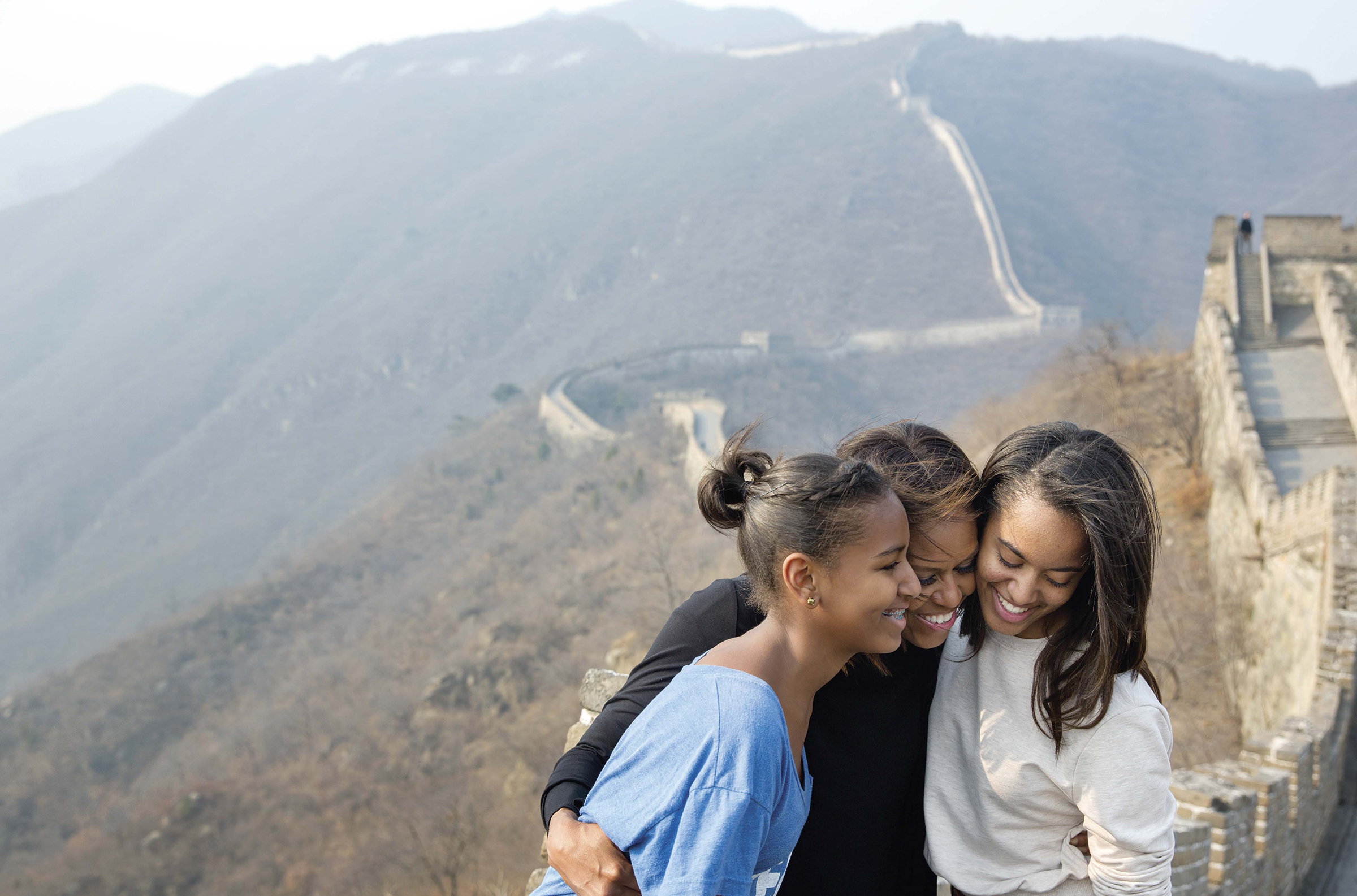 PHOTO: The First Lady hugs her daughters Sasha and Malia as they visit the Great Wall of China in Mutianyu, China, March 23, 2014. 