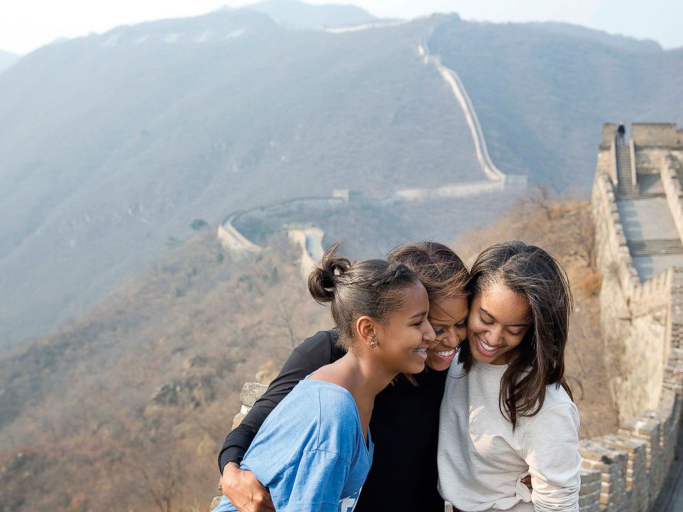 PHOTO: The First Lady hugs her daughters Sasha and Malia as they visit the Great Wall of China in Mutianyu, China, March 23, 2014.