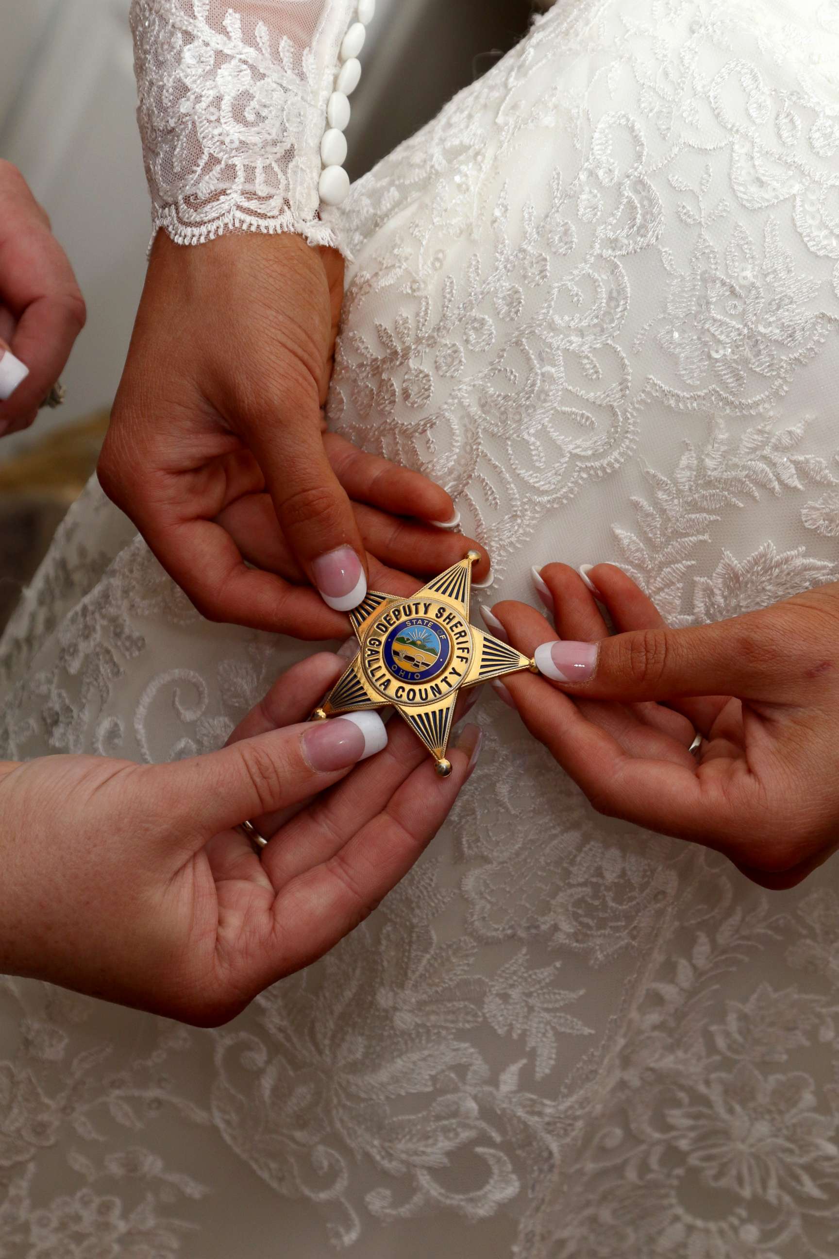 PHOTO: Mikayla Wroten of Crown City, Ohio, holds her father's badge on her Oct. 14 wedding day.