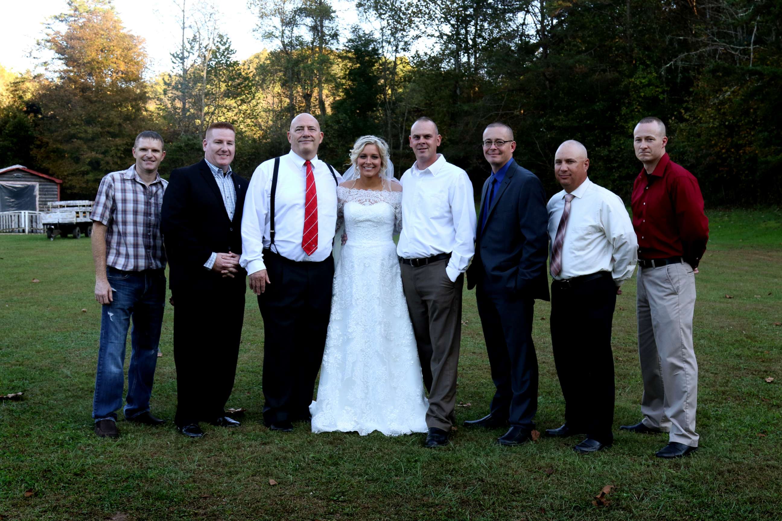 PHOTO: Mikayla Wroten poses with her father's former police colleagues after they surprised her with wedding dances.