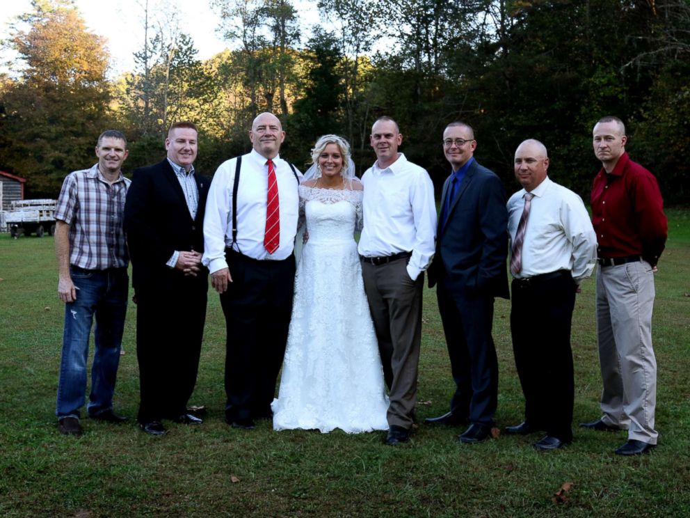 PHOTO: Mikayla Wroten poses with her fathers former police colleagues after they surprised her with wedding dances.