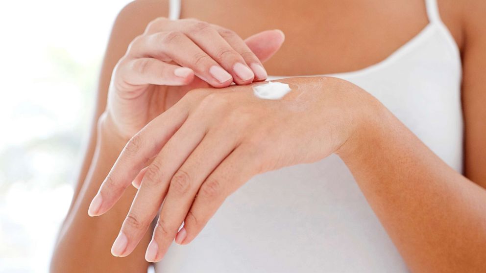 A woman applies moisturizer in this undated stock photo.