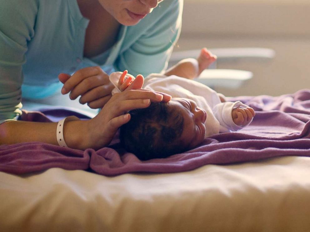 PHOTO: A mother sings to her newborn in this undated stock photo.