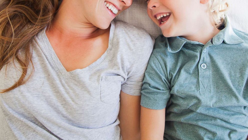 A portrait of a mother laughing with her son in this undated stock photo.