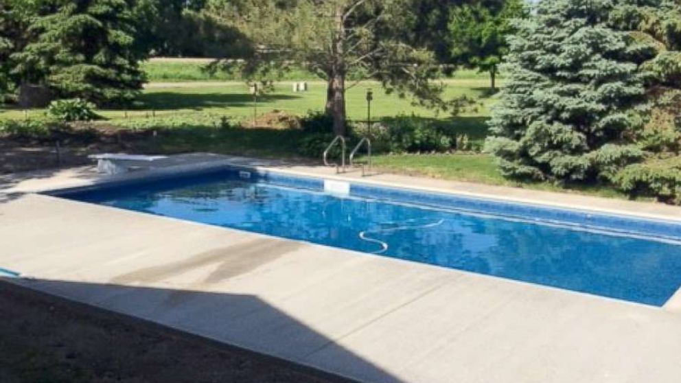 Keith Davison's finished pool created by Custom Pools complete with a diving board.