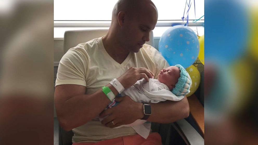 PHOTO: Michael Chuppa holds his newborn son, Blake, born July 10, 2017 at Hillcrest Hospital. Baby Blake is sporting a knit cap created by Barbara Lowe.