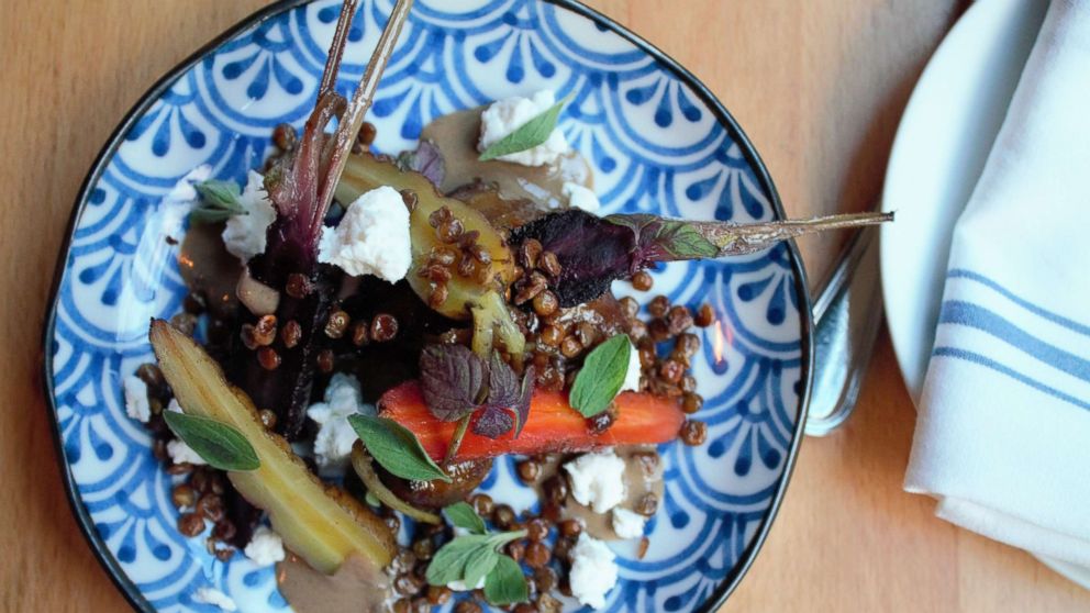 PHOTO: The root vegetable confit with baby carrots, sunchockes, goat cheese, tahini and silan.