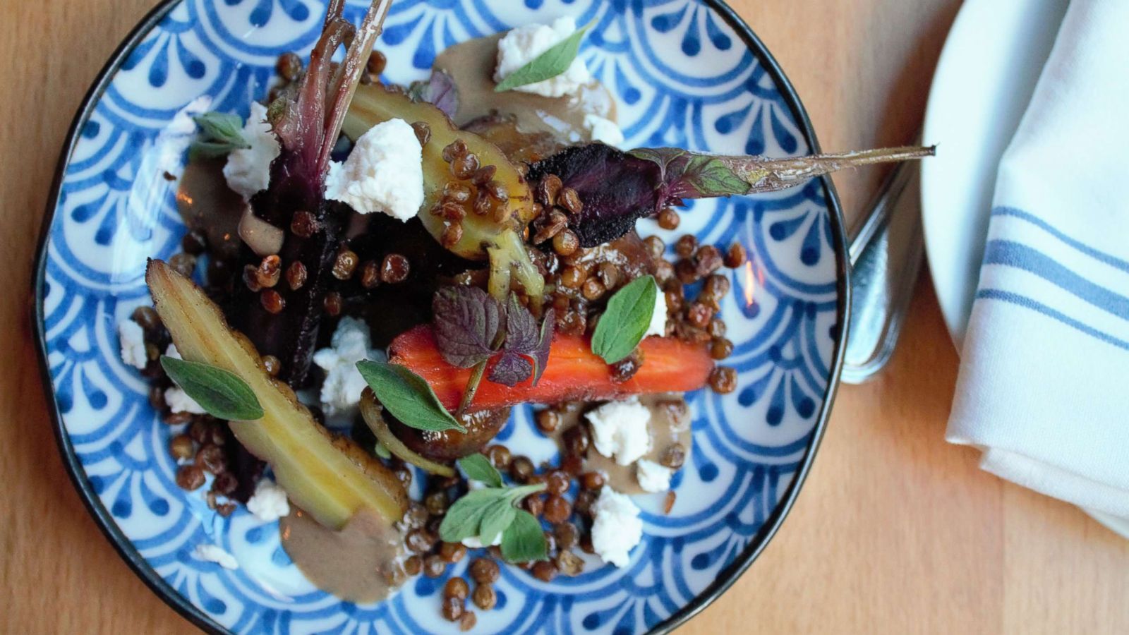 PHOTO: The root vegetable confit with baby carrots, sunchockes, goat cheese, tahini and silan.