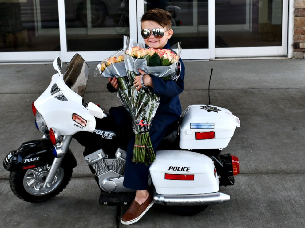 PHOTO: Officer Oliver Davis, 6, prepares to pass out roses and violations for being too cute to the senior residents of Westchester Village of Lenexa nursing home in Kansas.