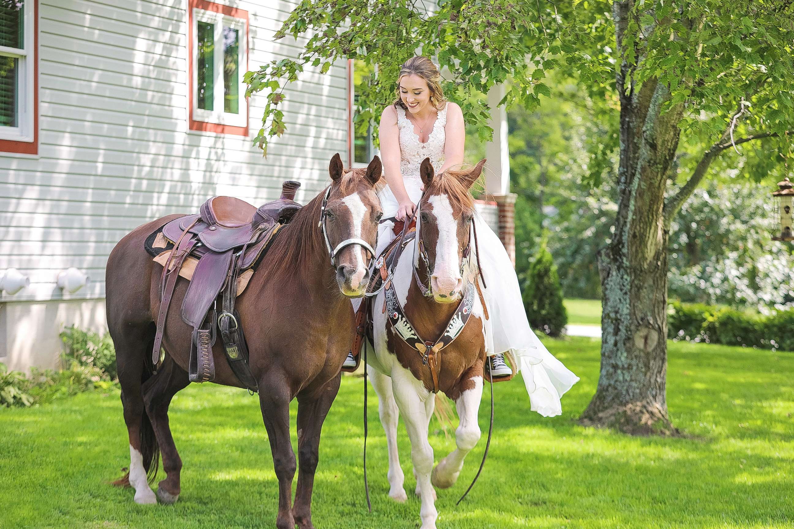 PHOTO: Patti Womer, 21, seen riding on her horse Cricket as her horse Dutch rode along side her on her wedding day, Sept. 9, 2017. 