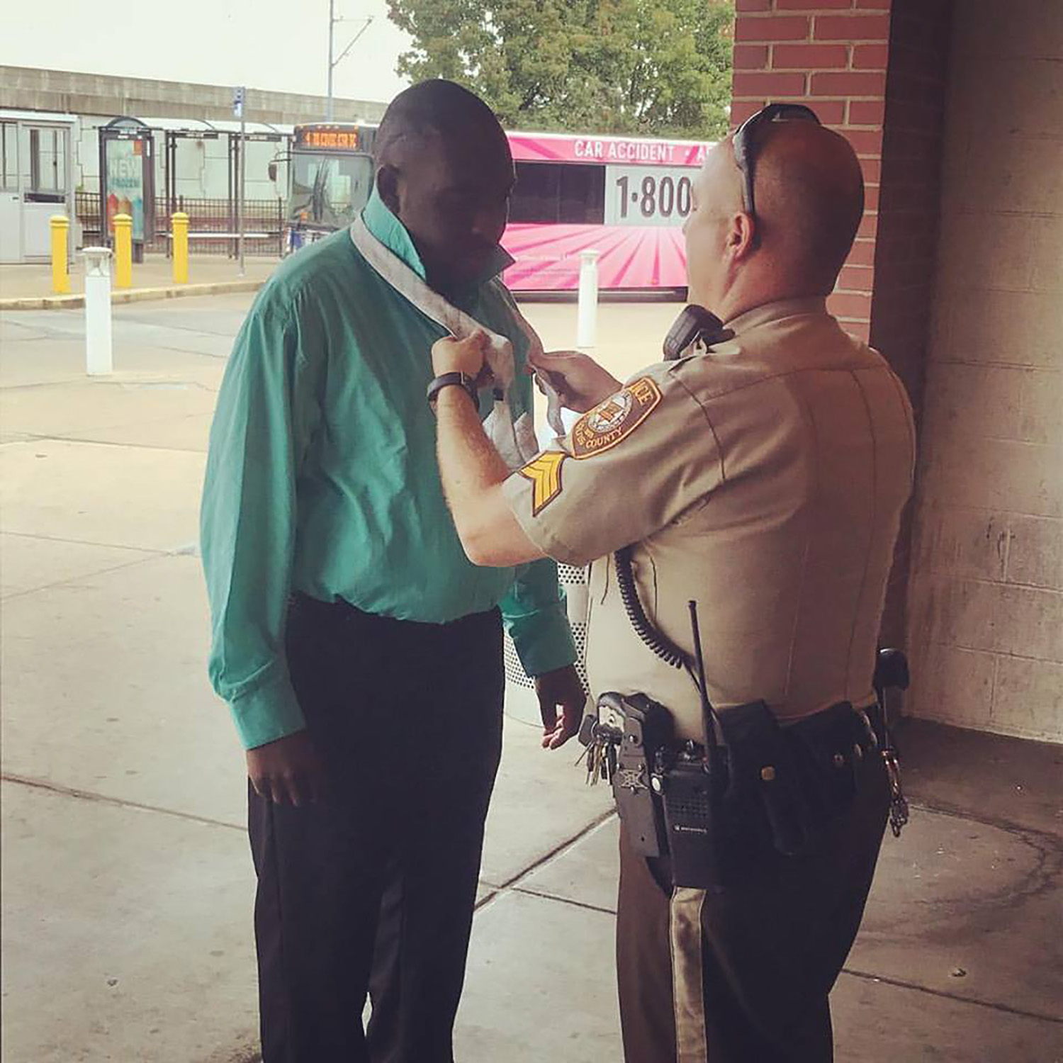PHOTO: Sergeant Howard Marshall helps Willie Hatcher tie his tie before a job interview in St. Louis, Sept. 18, 2017.