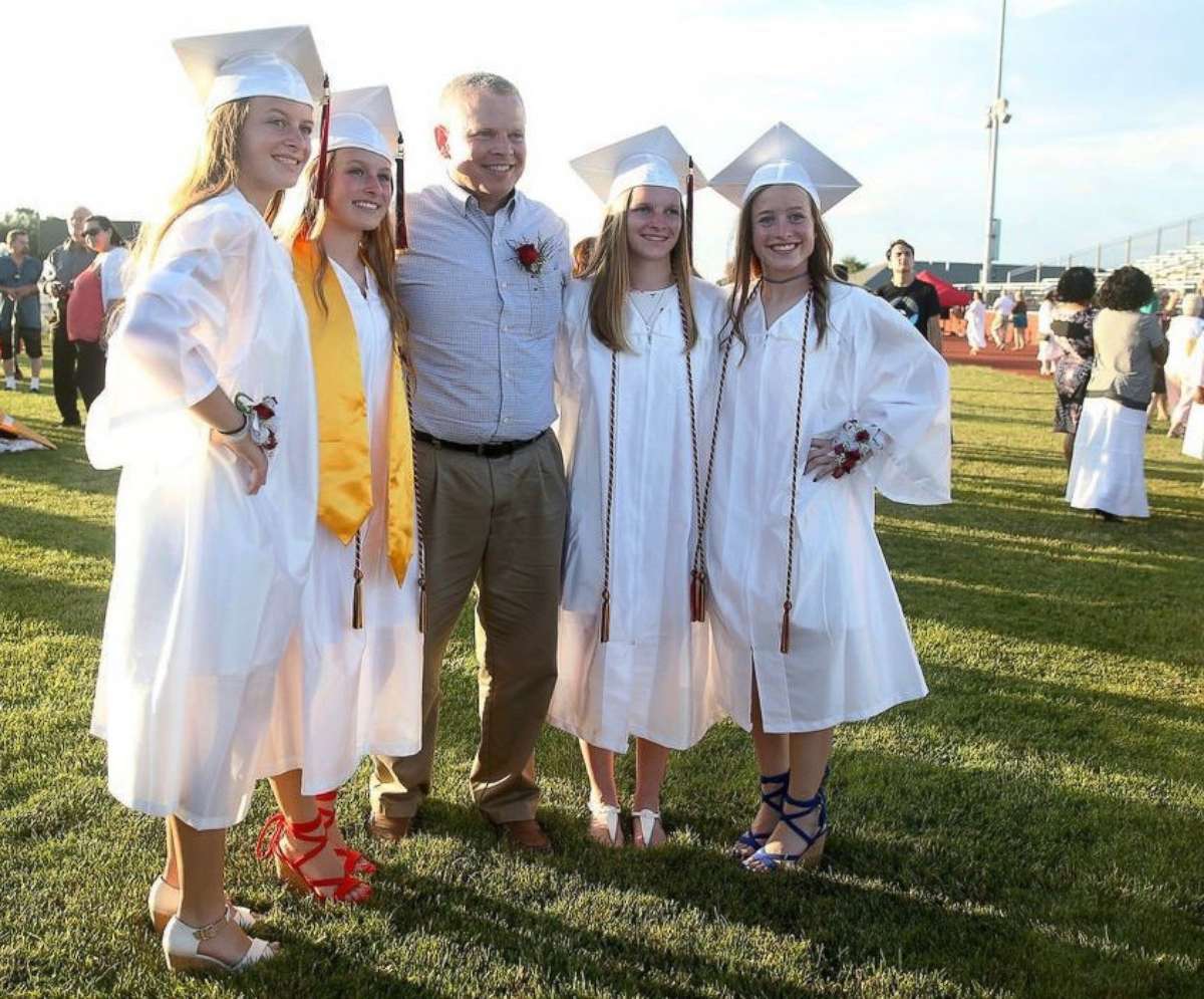 PHOTO: Rachel Murphy, Kelly Murphy, Erin Murphy and Casey Murphy, left to right, pose with their father, Michael Murphy, center, at their high school graduation.
