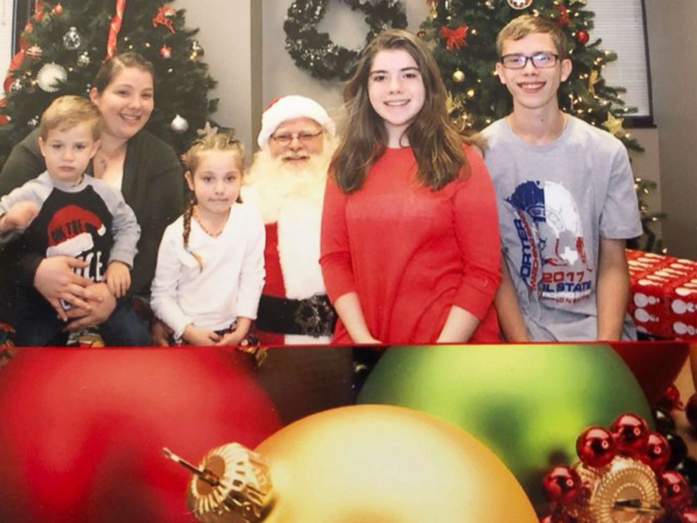 PHOTO: Robinn Graves and her children pose with Santa Claus.