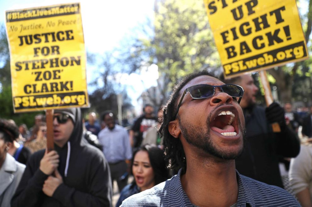 PHOTO: Black Lives Matter protesters hold signs as they stage a demonstration outside Sacramento City Hall on March 22, 2018, in Sacramento, Calif.