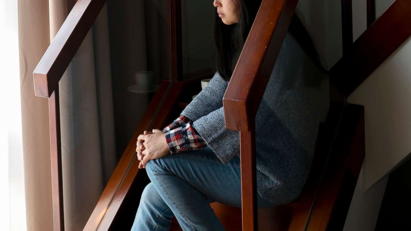 PHOTO: An unhappy looking woman sits on steps in an undated stock photo.