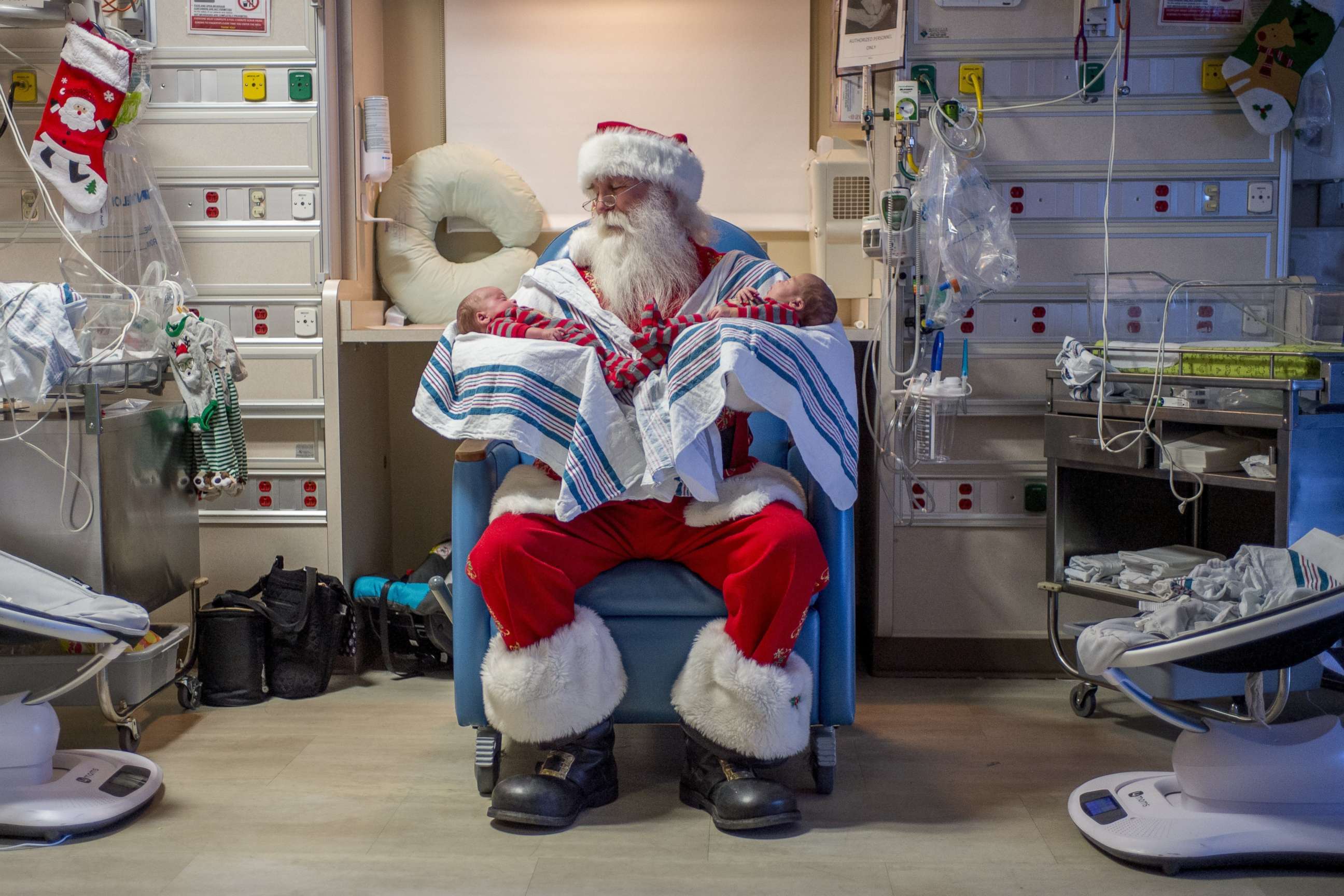 PHOTO: Santa Claus, portrayed by Dale Nowak, smiles as he holds 6-week-old Smith Sparks, left, and his twin brother Sullivan, at the Neonatal Intensive Care Unit, Dec. 6, 2017, at Hurley Medical Center in Flint, Mich.