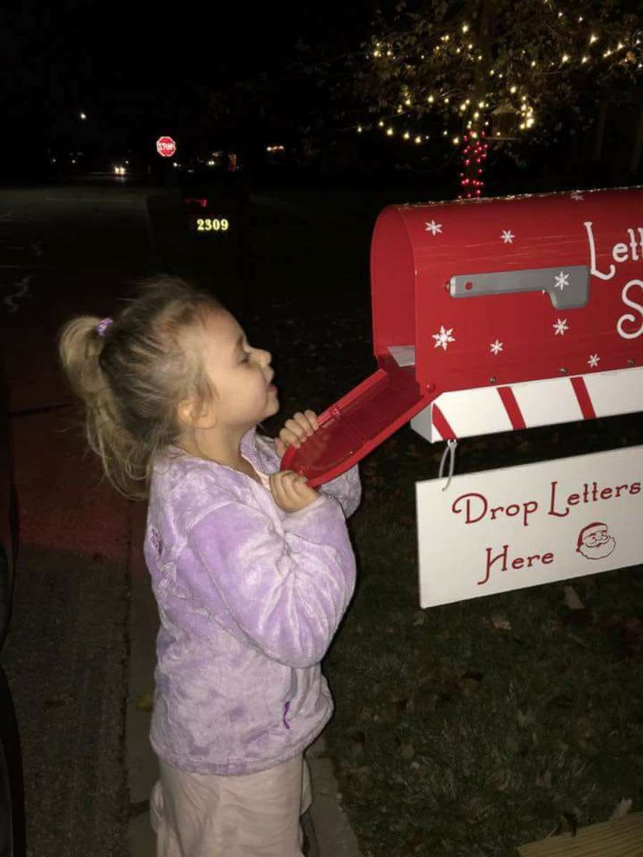 PHOTO: Dylann Dutton peeks inside the magical Letters to Santa mailbox.