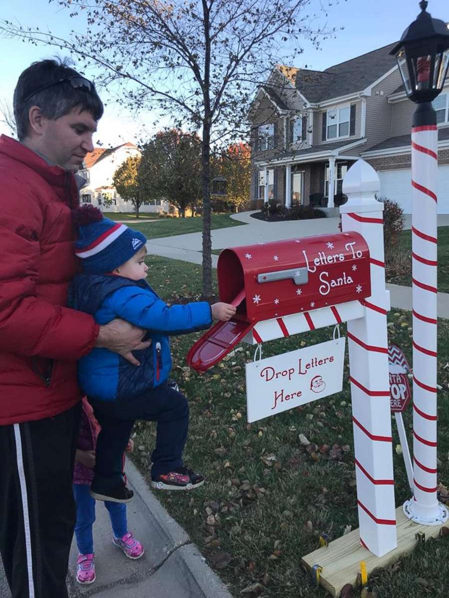 PHOTO: Austin Falli drops off his letter with his daddy holding him up to the mailbox. 