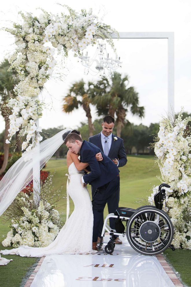 PHOTO: Chris Norton and Emily Summers-Norton standing together as newlyweds.